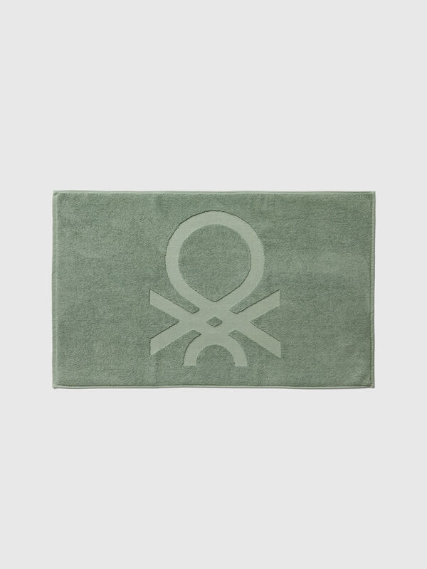 Green bathroom rug with logo